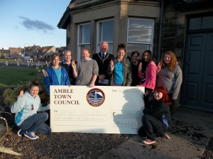 Mayor, Craig Weir, presenting the donation to Amble Rangers with their Leader, Jan-Marie Claridge.